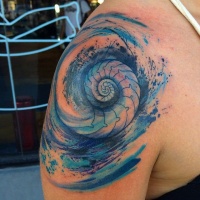 Watercolor style colored shoulder tattoo of nautilus