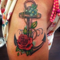 Wonderful colored iron anchor with flowers tattoo on thigh