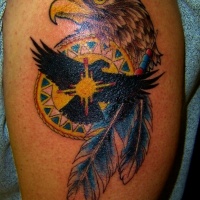 Wonderful colorful eagle head and feathers tattoo on shoulder