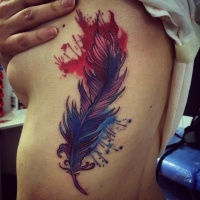 Wonderful colorful feather with splashes tattoo on side