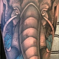 Wonderful colorful mammoth head tattoo on upper arm