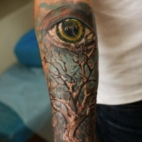 Wonderful colorful tree and eye on blue background tattoo sleeve on forearm