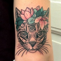 Mysterious colored arm tattoo of cat head with flowers