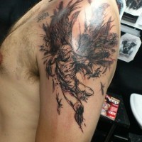 Abstract black flying angel tattoo on shoulder