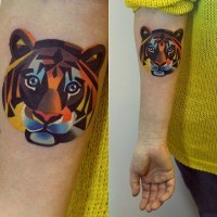 Abstract geometrical style colored little tiger head tattoo on arm