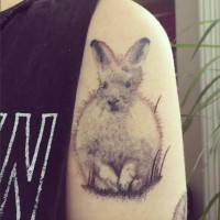 Abstract like natural looking funny white colored shoulder tattoo on cute rabbit