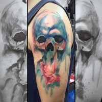 Abstract style big colored watercolor skull shoulder tattoo with mystical flower