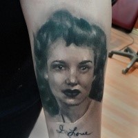 Abstract style black and white woman portrait tattoo on upper arm