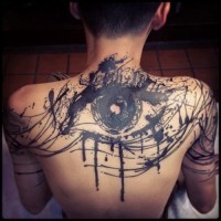 Abstract style black ink big eye tattoo on upper back and shoulders