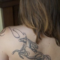 Abstract style black ink big horse tattoo on back