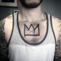 Abstract style black ink chest tattoo of crown