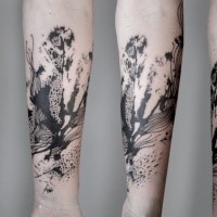 Abstract style black ink forearm tattoo of various plants