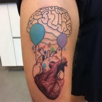 Abstract style colored arm tattoo of human heart with balloons and brain