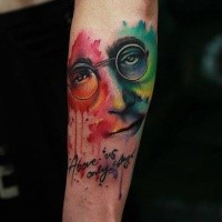 Abstract style colored arm tattoo on Lennon face with lettering