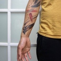 Abstract style colored forearm tattoo of various ornaments