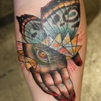 Abstract style colored leg tattoo of human hand with butterfly wings and eye