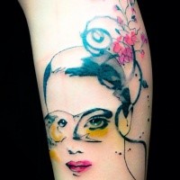 Abstract style colored leg tattoo of woman face with flowers