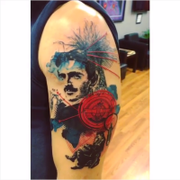 Abstract style colored shoulder tattoo of Nikola Tesla