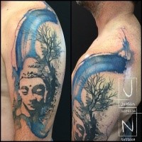 Abstract style colored shoulder tattoo of Buddha statue with tree