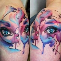 Abstract style colored shoulder tattoo of woman eyes