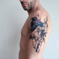 Abstract style colored shoulder tattoo of bird in jungle