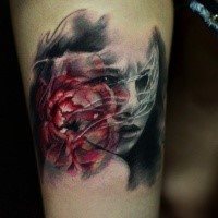 Abstract style colored thigh tattoo of woman face with heart