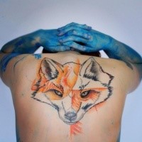 Abstract style colored upper back tattoo of fox head