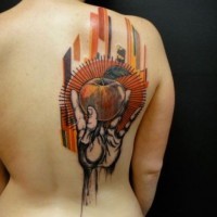 Abstract style colorful hand with apple on upper back tattoo