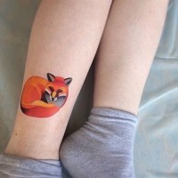 Abstract style designed and colored little sleeping fox tattoo on ankle