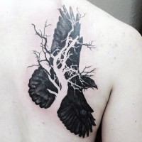 Abstract style half tree half crow tattoo on shoulder