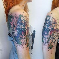 Abstract style multicolored lion face tattoo on shoulder with various ornaments