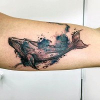 Abstract style painted colorful big whale tattoo on arm