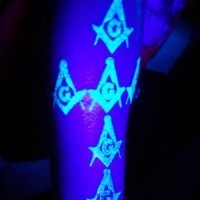 Abstract symbols black light tattoo on hand