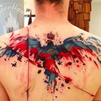 Abstract watercolor style painted and colored bird tattoo on upper back