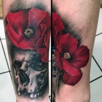 Accurate detailed and colored red flower with skull tattoo on arm