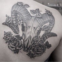 Accurate dot style scapular tattoo of animal skull and flowers