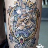 Accurate painted and colored little rabbit portrait tattoo on thigh with lettering