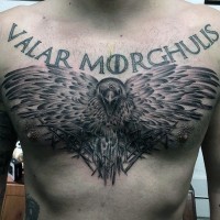 Accurate painted black and white mystic crow with lettering tattoo on chest