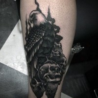 Accurate painted black ink eagle with skulls tattoo on thigh