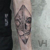 Accurate painted by Valentin Hirsch forearm tattoo of split lion head with