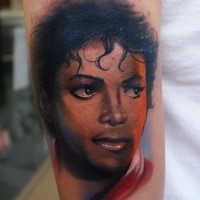 Accurate painted colored arm tattoo of Michael Jackson face