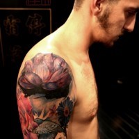 Accurate painted colored lotus flower tattoo on shoulder combined with flying bird