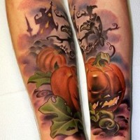 Accurate painted colorful Halloween like pumpkin tattoo on forearm with old house and crow