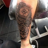 Accurate painted massive black and white old compass with antic key and flower tattoo on arm