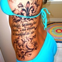 Tatuaje en el costado, flor de lis con patrones y inscripcion, diseño elegante