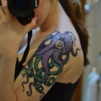 Alien like multicolored little octopus tattoo on shoulder
