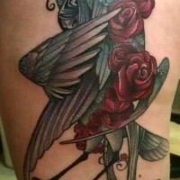 Amazing bird with red flowers tattoo on thigh