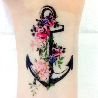 Amazing black anchor with flowers tattoo on wrist
