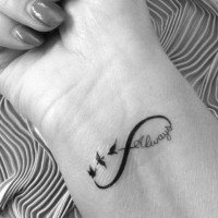 Amazing black ink tattoo on wrist for girls