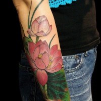 Tatuaje en el antebrazo, flores de loto con hojas